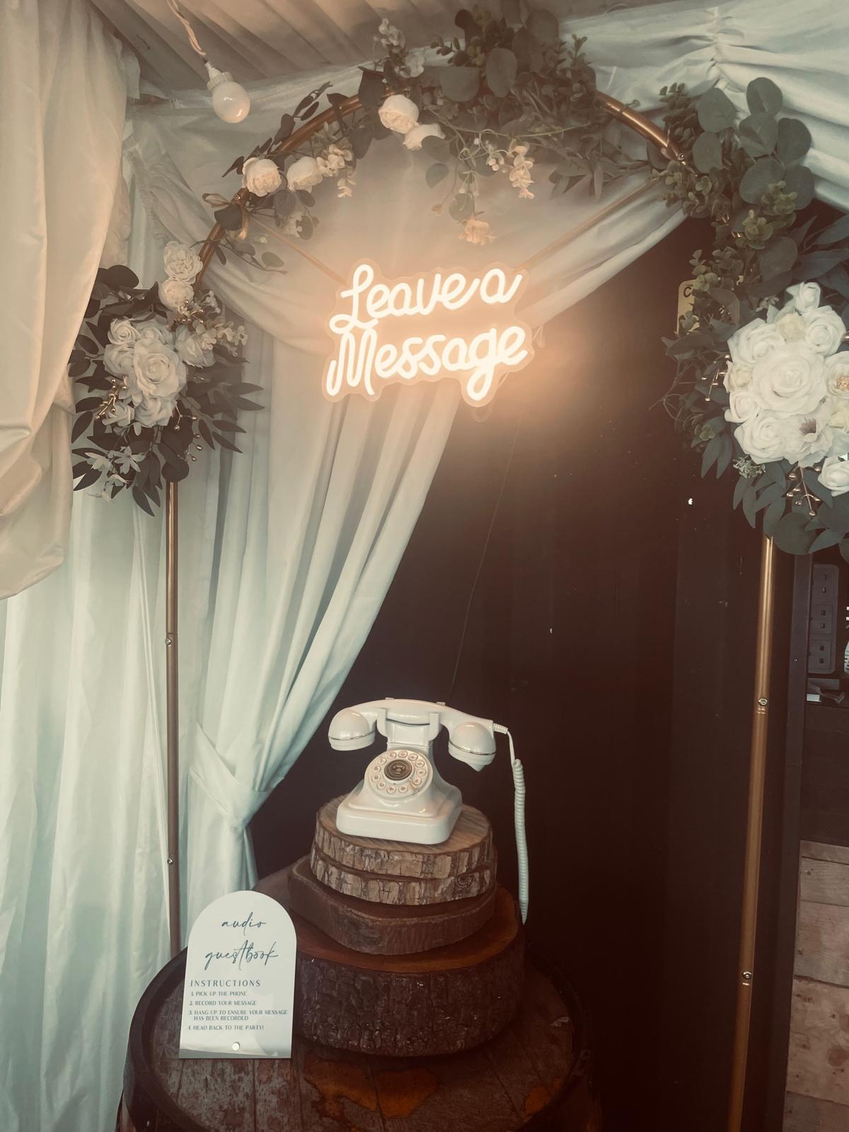 Vintage audio guestbook phone with fairy lights and a neon Leave a Message sign